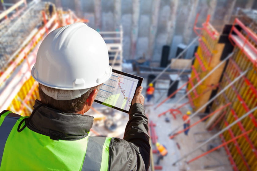 construction worker using forms on tablet for construction site reports