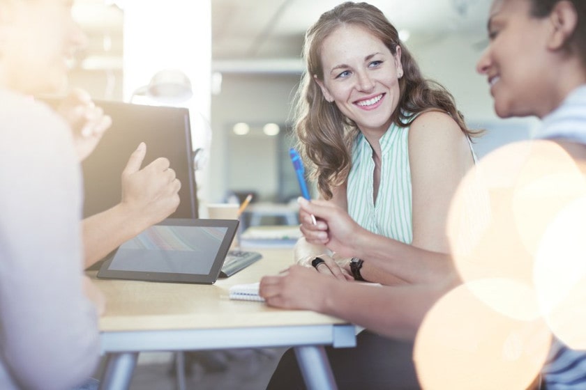 Unposed group of business people in an office brainstorming their pilot program